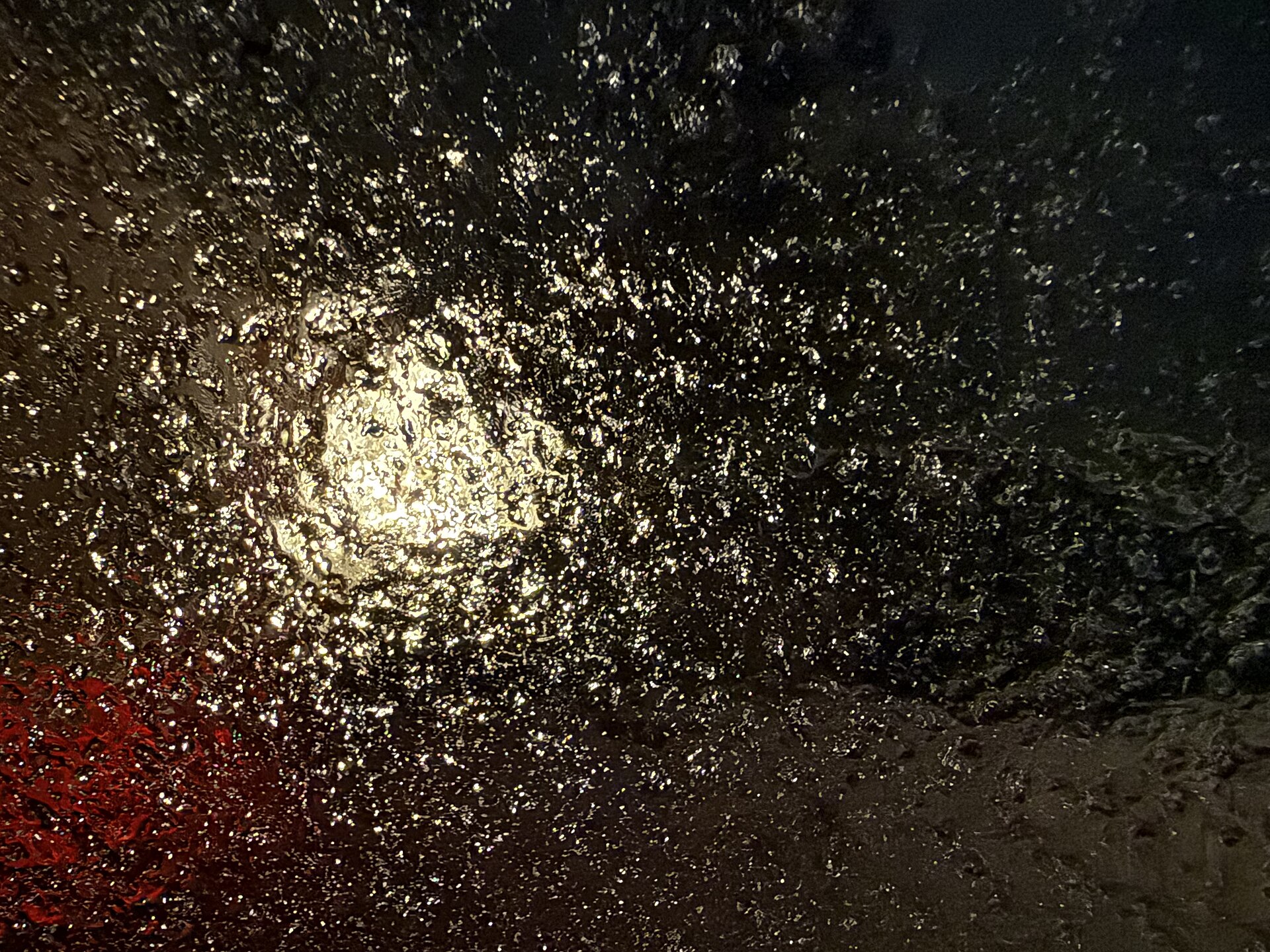 2025-02-06 06 22 58 A glaze of freezing rain viewed through a car window at night along Aquetong Lane in the M